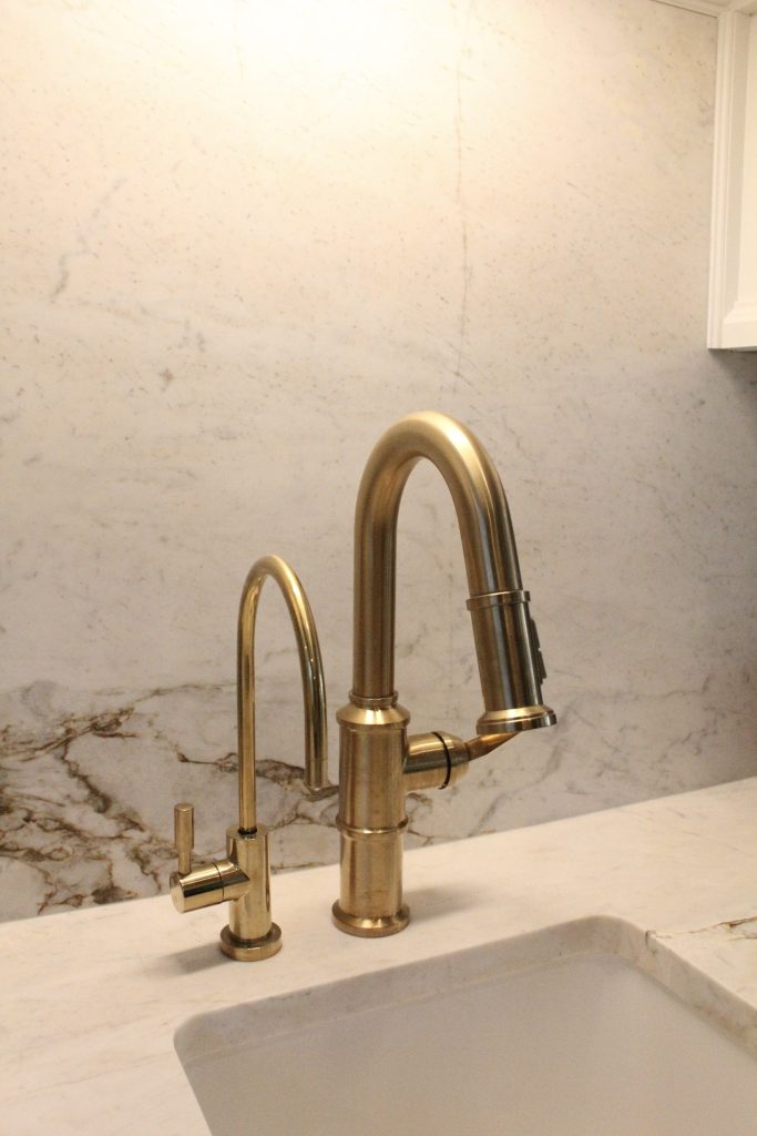 Brass Faucet against Quartz backsplash