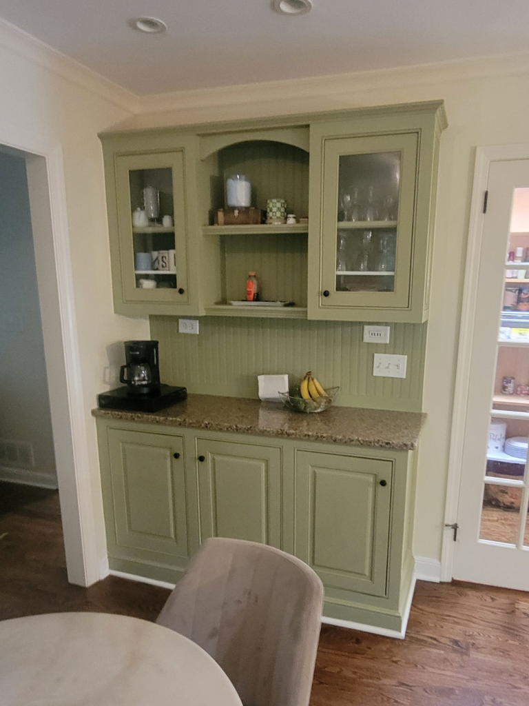 photo of hutch with green cabinetry and marble countertops