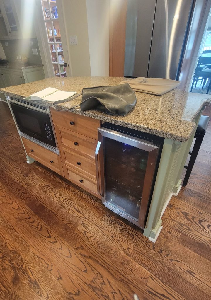 Warm wood island with marble countertop