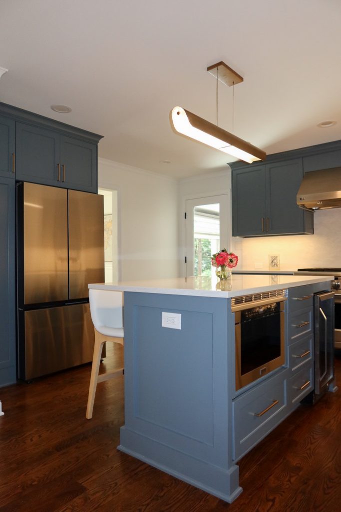 photo centered of Deep blue kitchen island with range in the back
