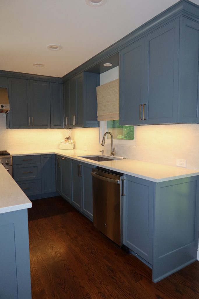photo centered of Deep Blue Kitchen cabinets along wall with kitchen sink