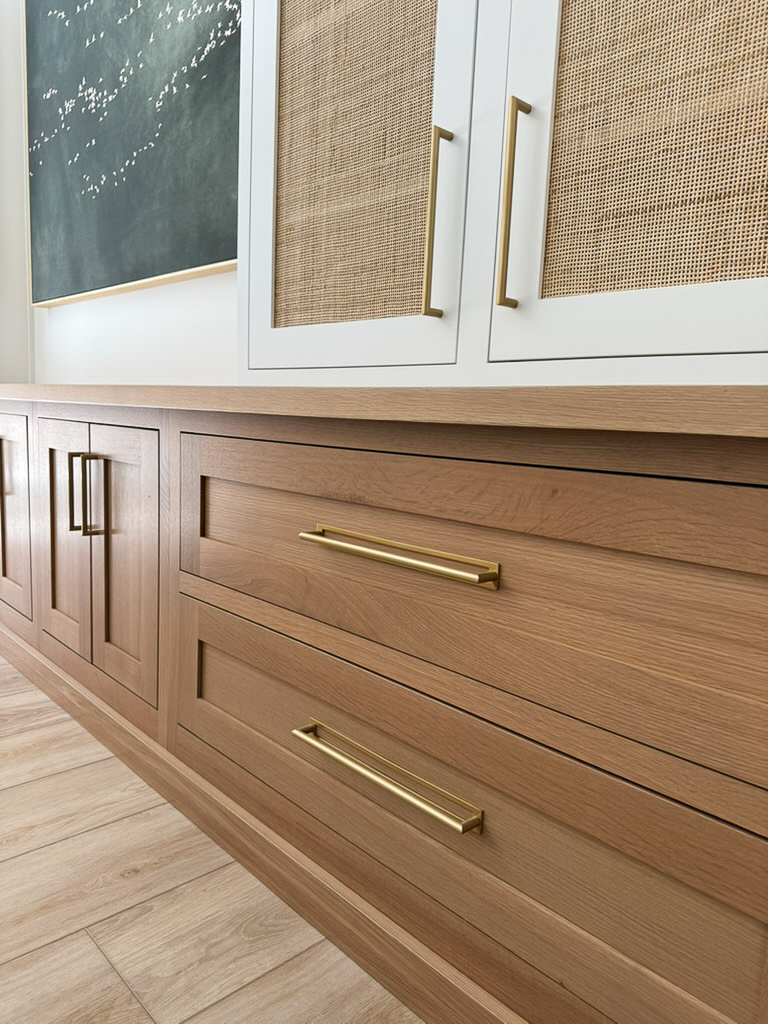 close up of white oak drawers featured in a wall-length bookshelf