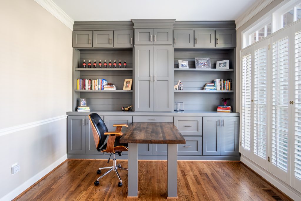 traditional office with gray cabinetry and wooden desk
