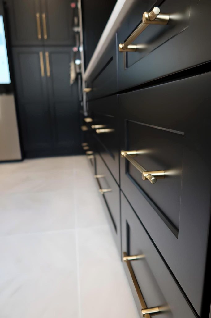 black cabinetry contrasted against gold pulls