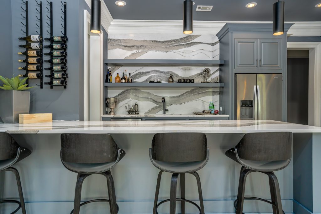 Blue basement bar with white and black quartz countertop and backsplash