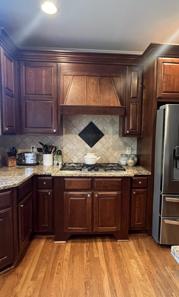 before image of traditional kitchen with brown wooden cabinets and granite countertop