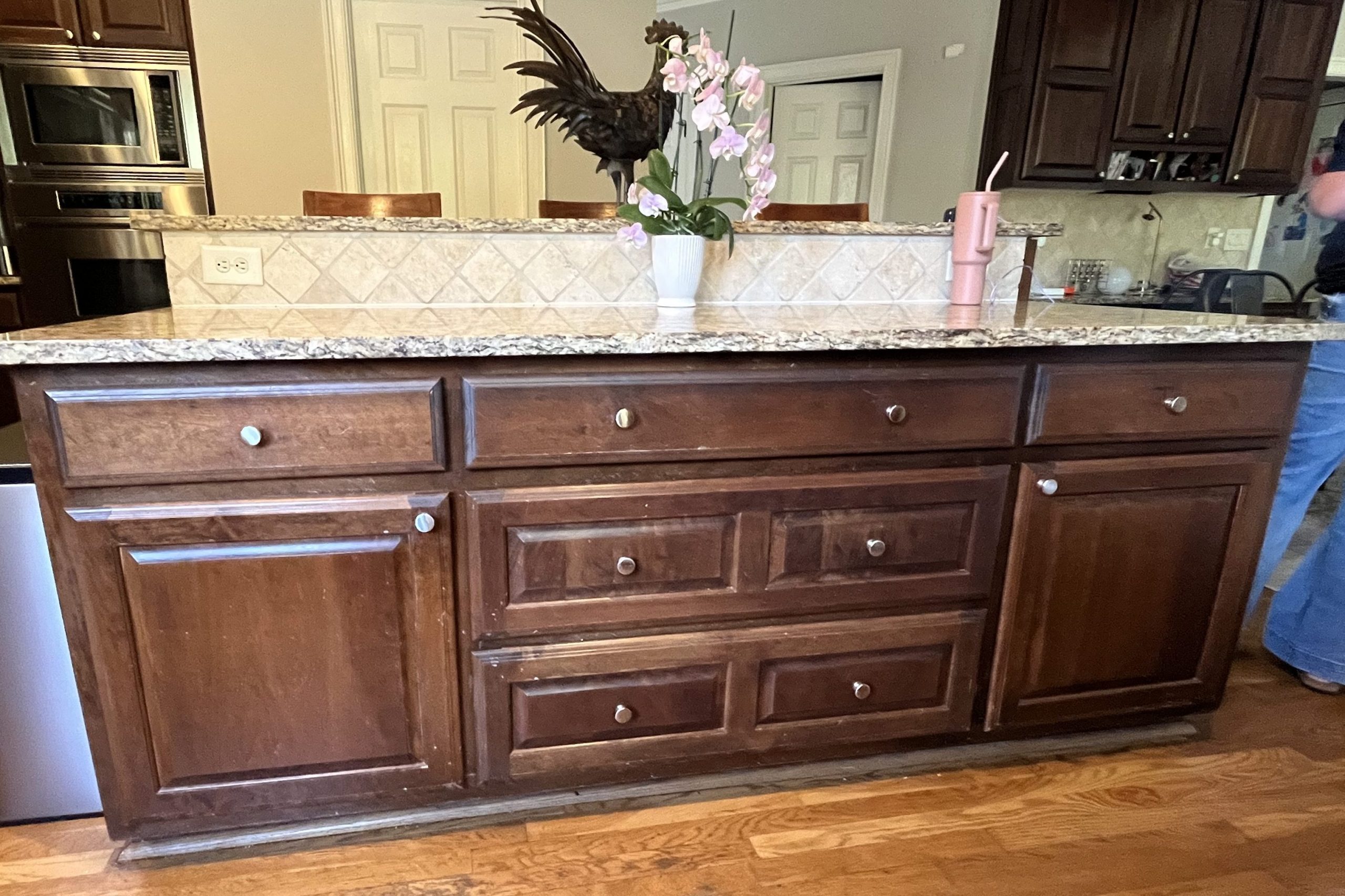before image of traditional kitchen with brown wooden cabinets and granite countertop