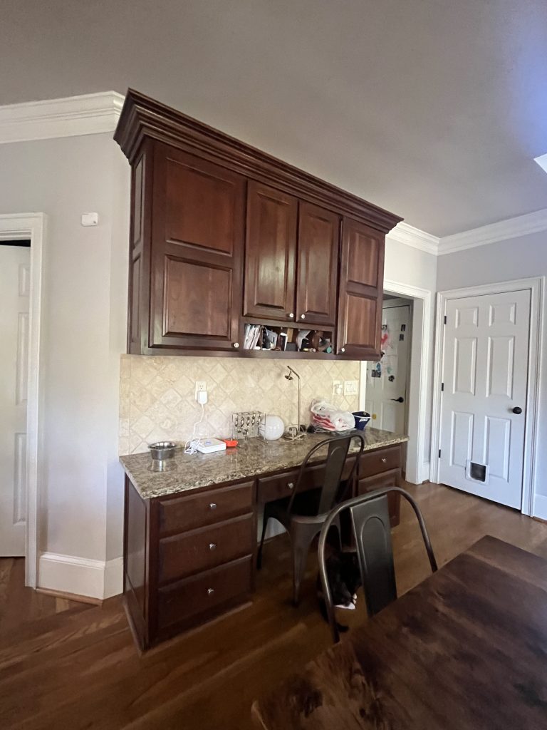 before image of traditional wet bar with brown wooden cabinets and granite countertop