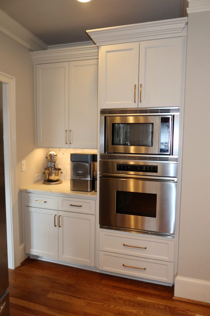 modern white kitchen with waterfall quartz island