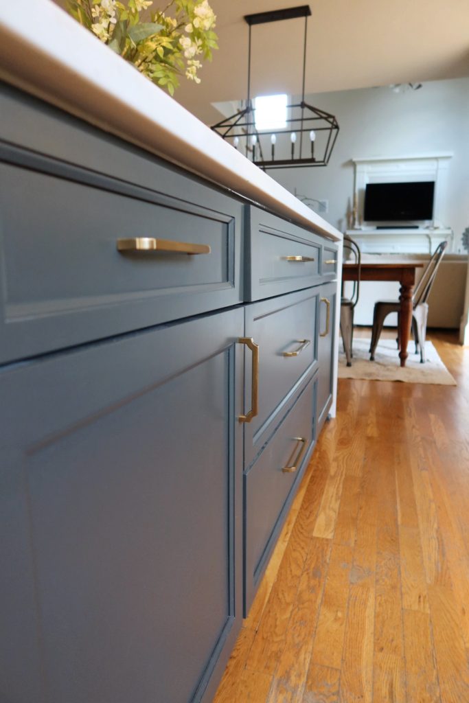 rich blue cabinetry with gold pulls