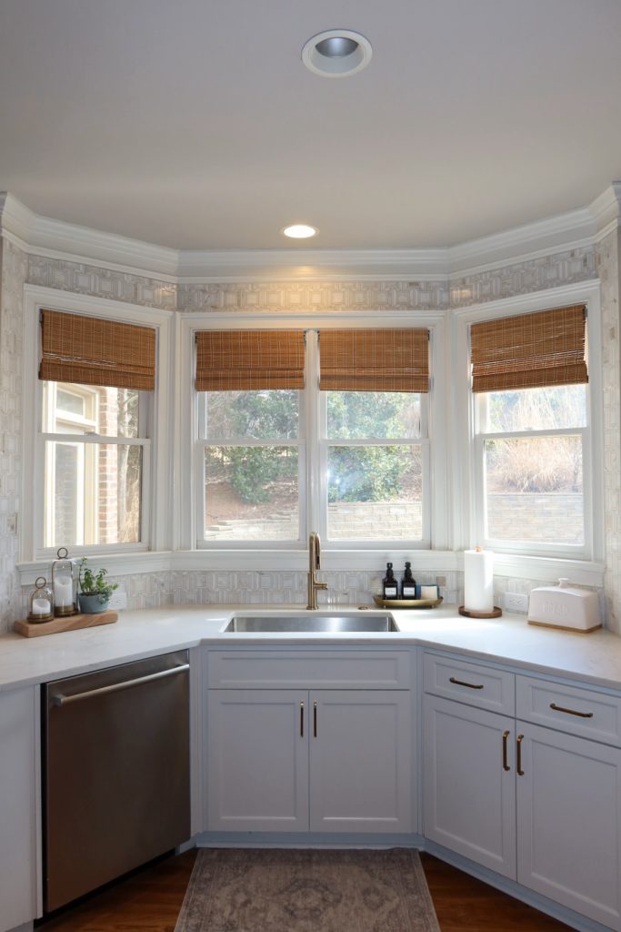 modern white kitchen with gold hardware and faucet sink