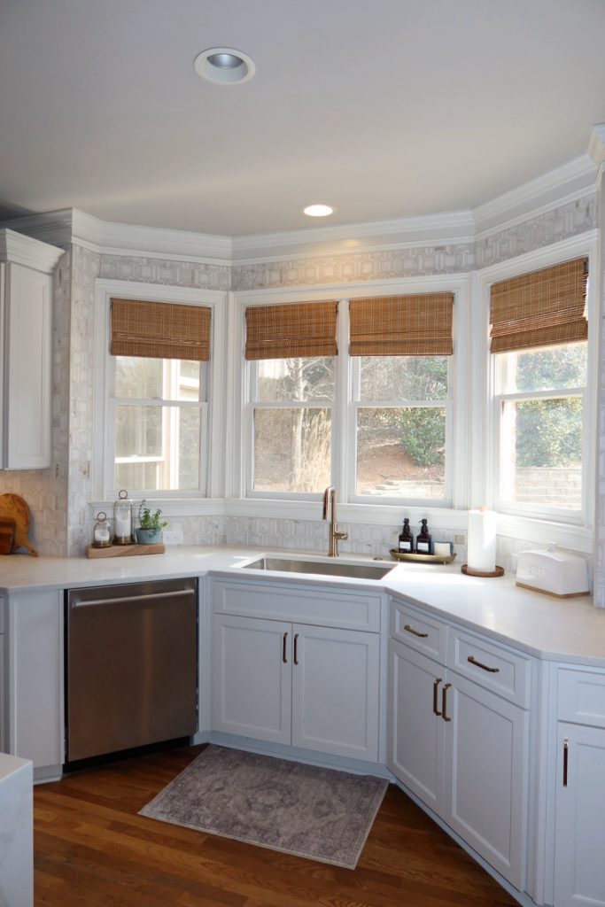 modern white kitchen with gold hardware and faucet sink