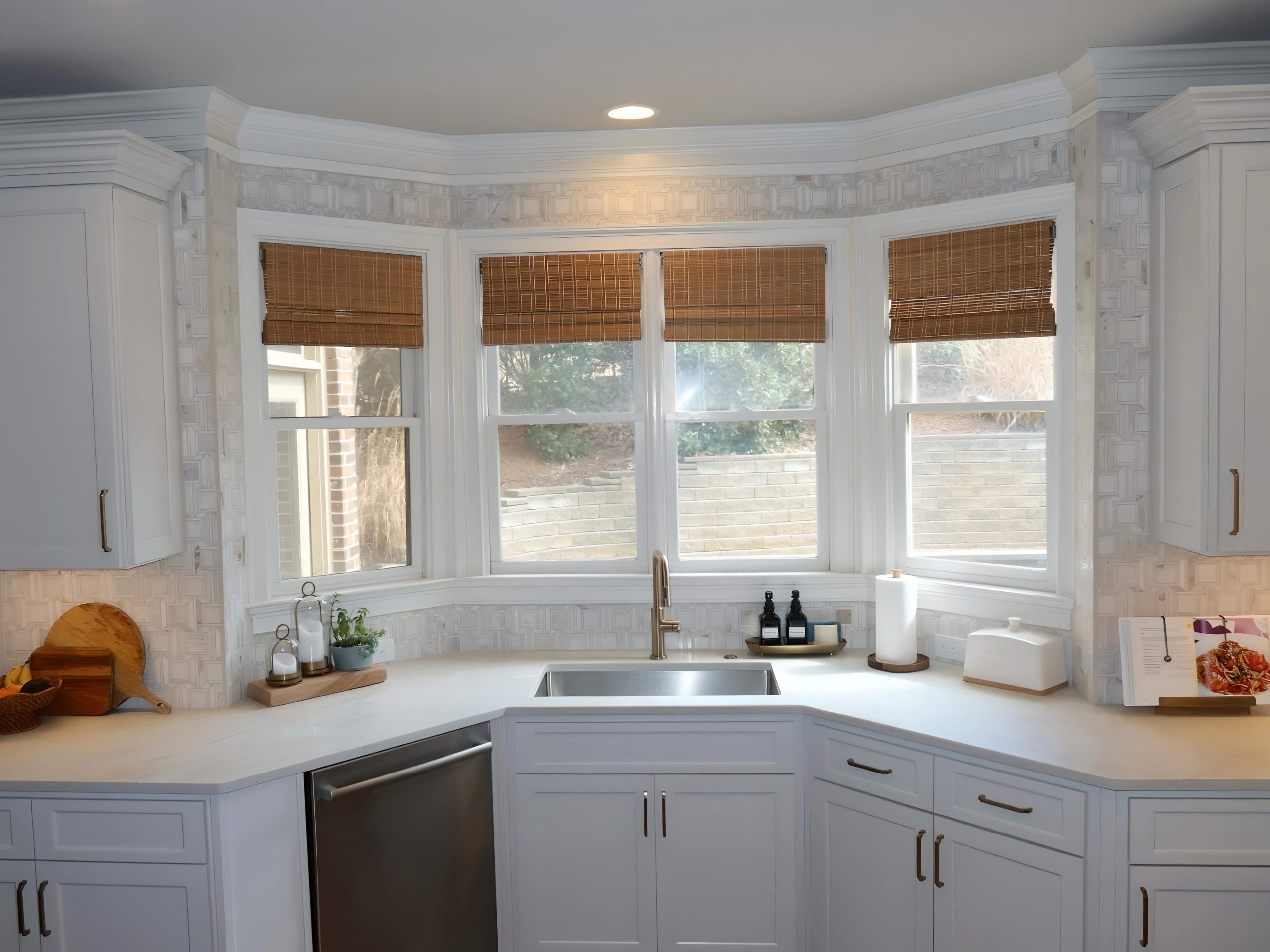 modern white kitchen with gold hardware and faucet sink