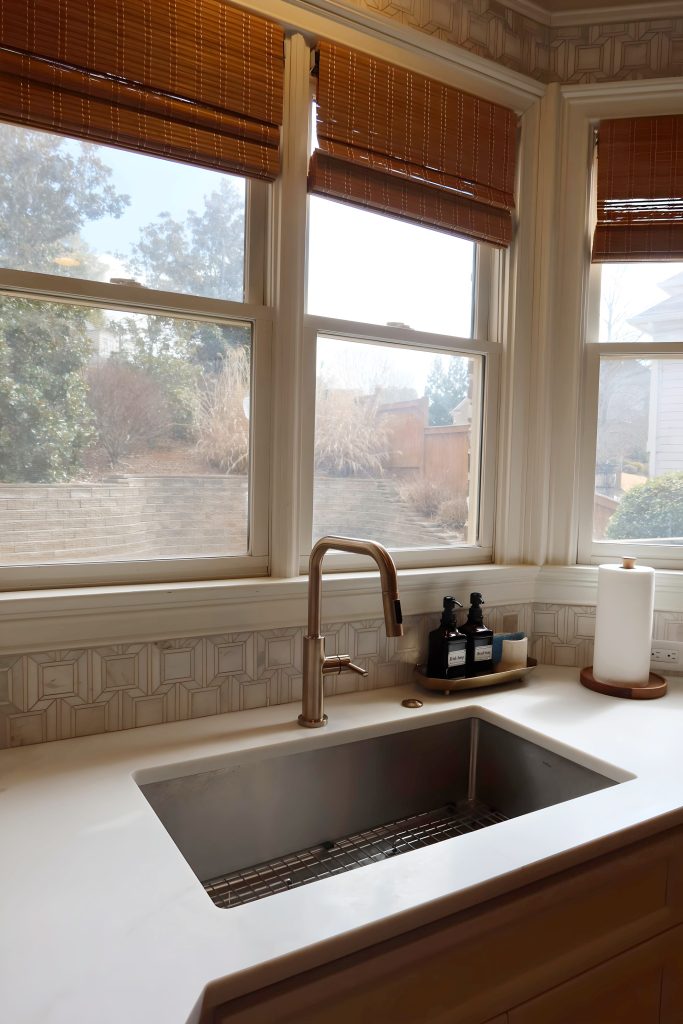 modern white kitchen with gold hardware and faucet sink