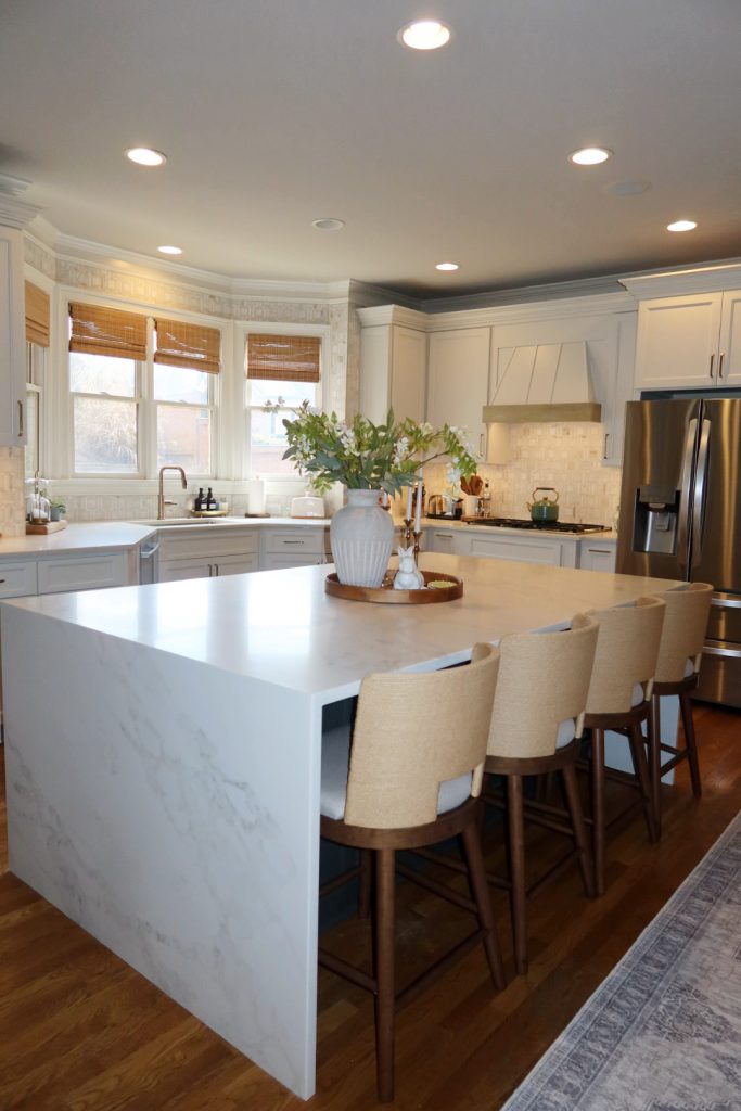 modern white kitchen with waterfall quartz island