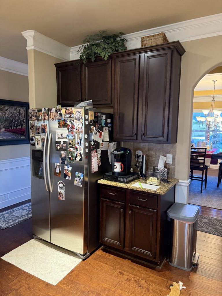 Traditional kitchen with dark wood cabinets and granite countertops before renovation