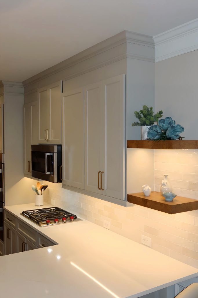 Modern kitchen with neutral cabinetry and wooden floating shelves