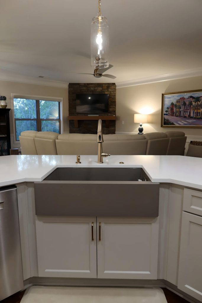Modern kitchen with concrete farmhouse sink and gold fixtures