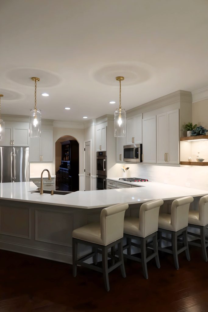 Modern kitchen with light neutral cabinetry, quartz countertops, and built-in stainless steel appliances