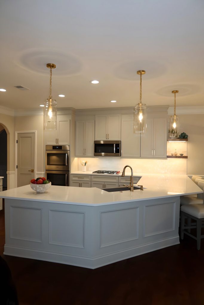 Modern kitchen with light neutral cabinetry, quartz countertops, and built-in stainless steel appliances