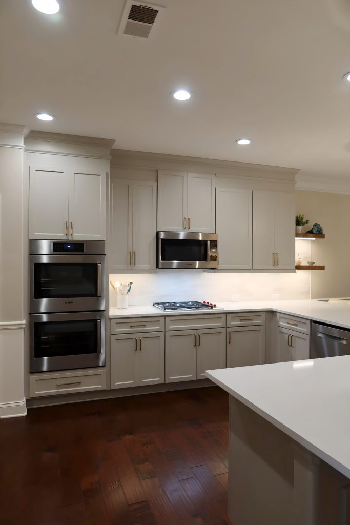 Modern kitchen with light neutral cabinetry, quartz countertops, and built-in stainless steel appliances