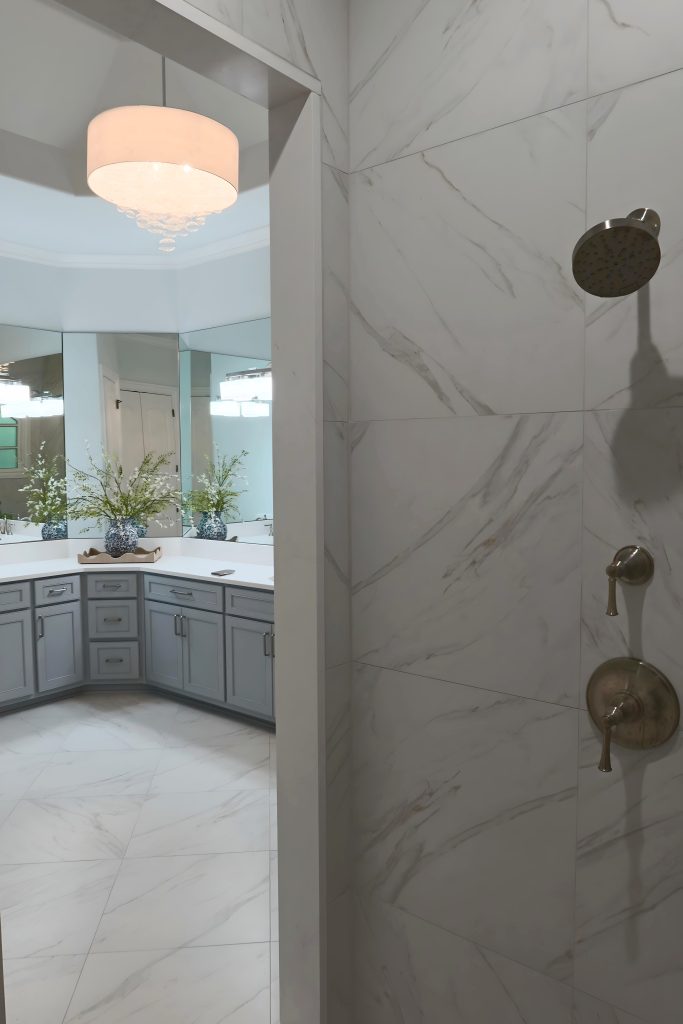 primary shower with blue cabinetry in back