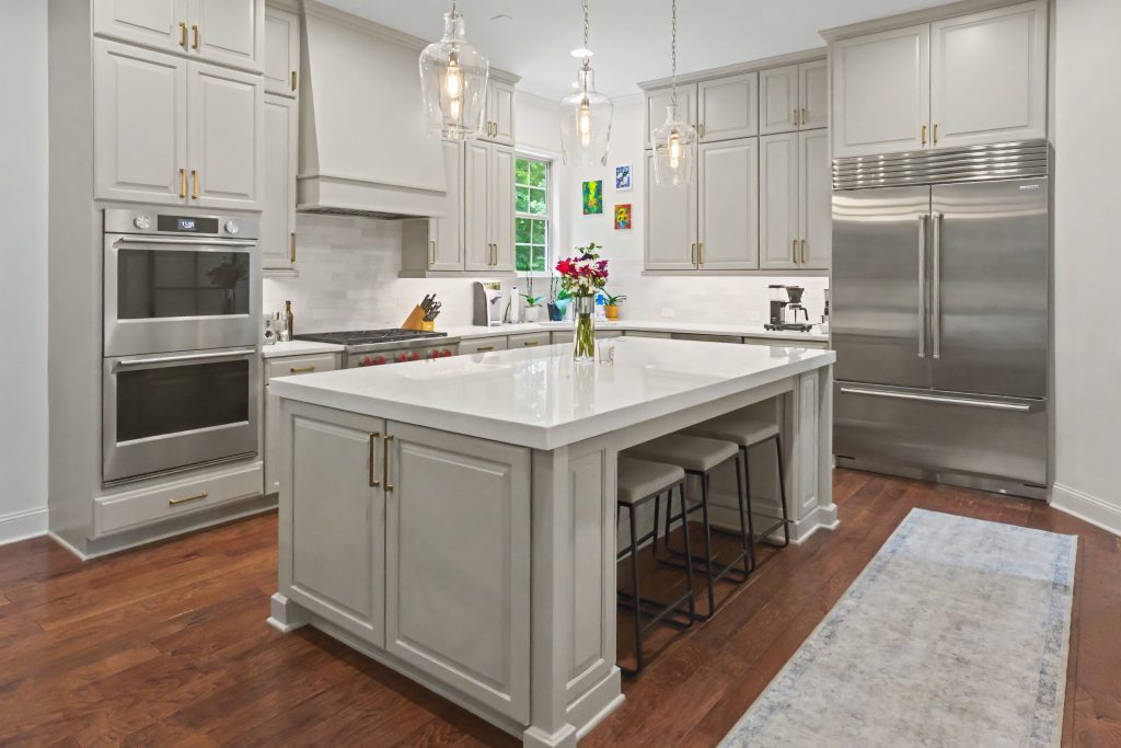 Modern white kitchen with white cabinetry and white countertop