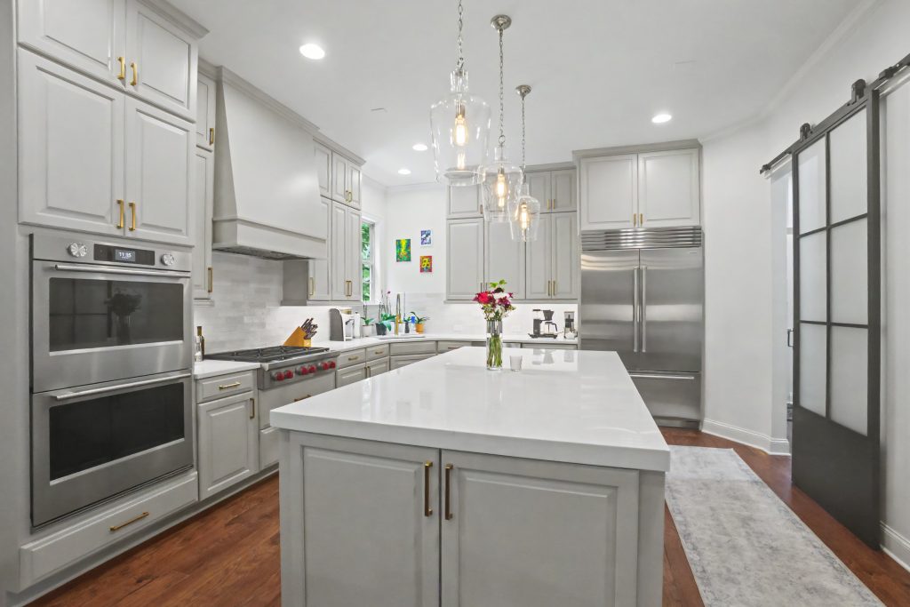Modern white kitchen with white cabinetry and white countertop