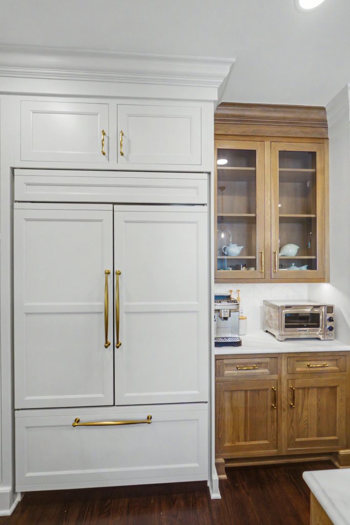 anel-ready Sub-Zero refrigerator with white inset cabinetry and custom wood accents